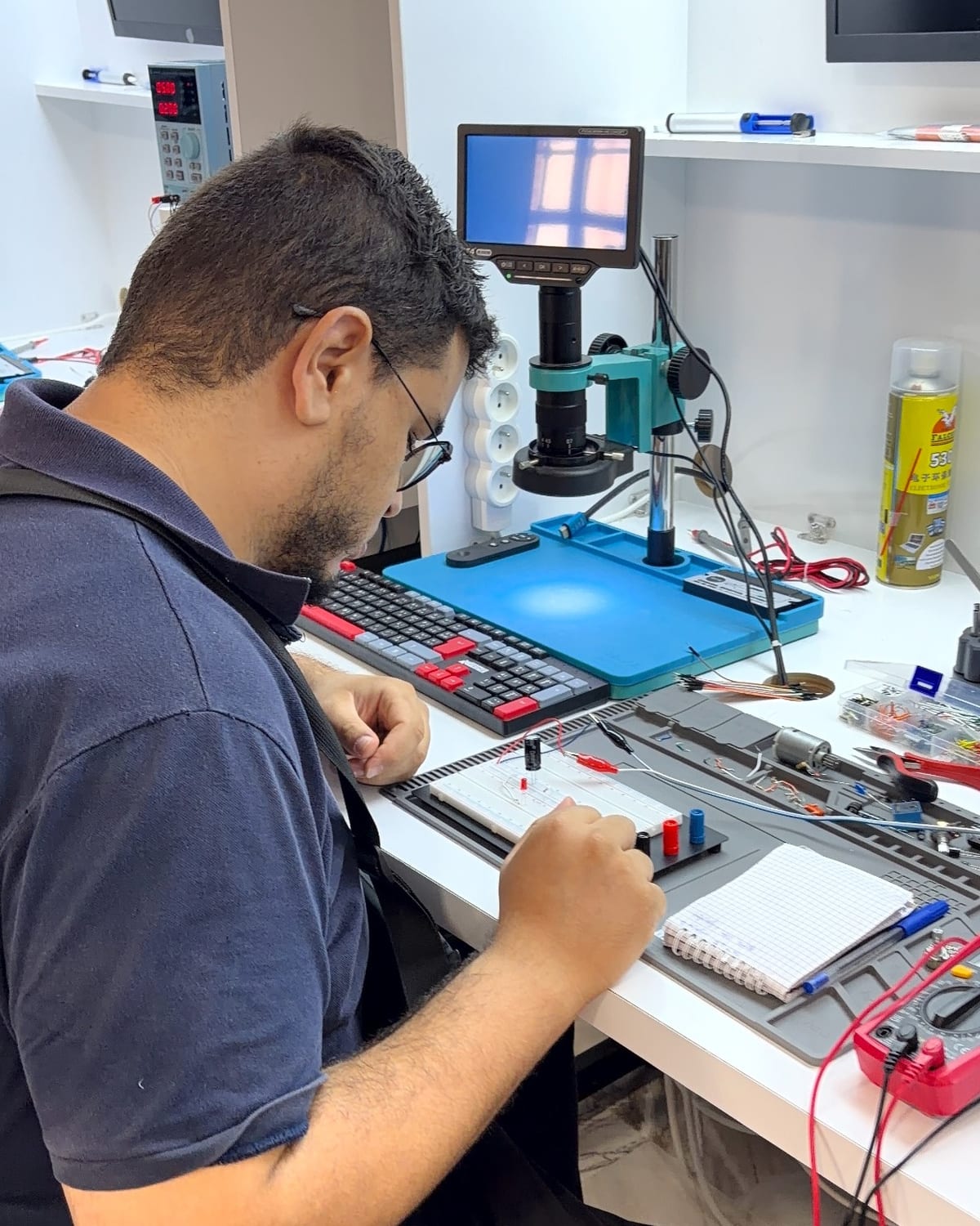 SSP Academy trainer working at an electronics workstation