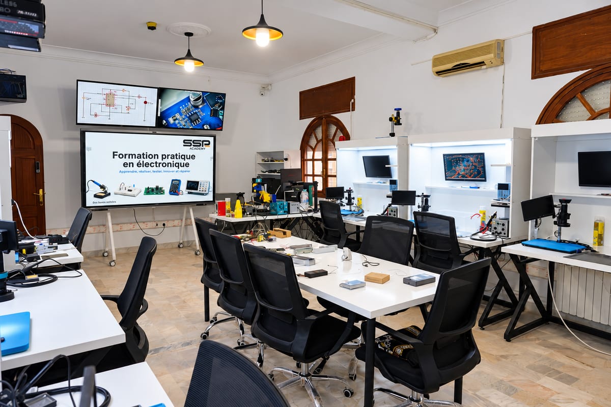 Electronics workshop: technical workstations with microscopes, screens and measuring instruments